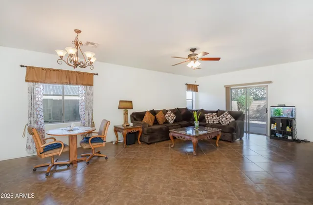 a living room with furniture a fireplace and a chandelier