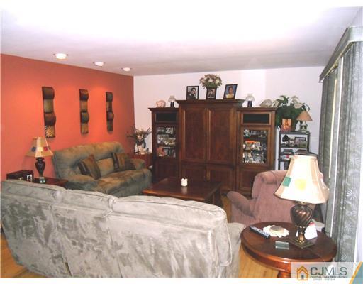 242 New Road Monmouth Junction, NJ 08852 - Photo 3 of 11 a bed room with a bed and a television