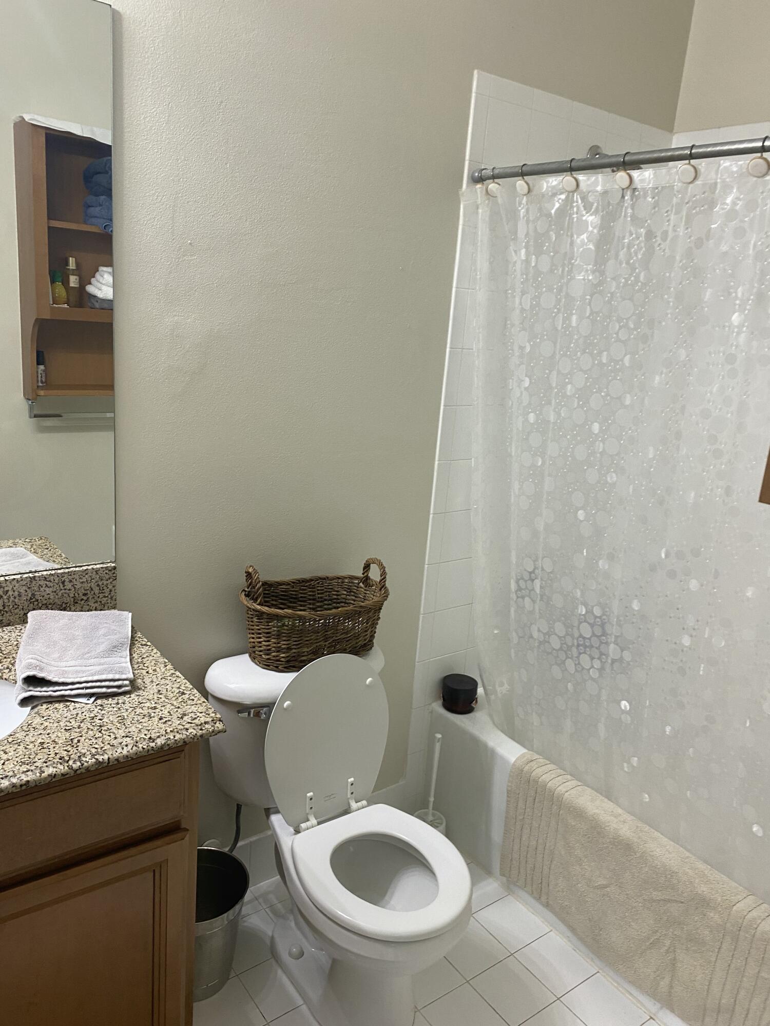 101 Lighthouse Circle, Unit J Tequesta, FL 33469 - Photo 12 of 13 a white toilet sitting next to a bath tub