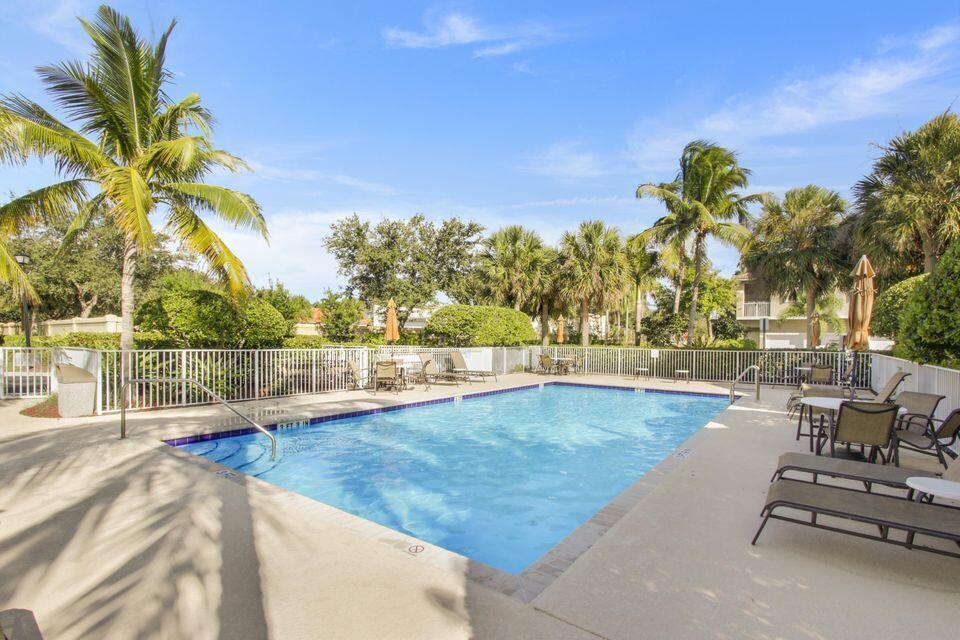 101 Lighthouse Circle, Unit J Tequesta, FL 33469 - Photo 3 of 13 a view of swimming pool with outdoor seating and a yard