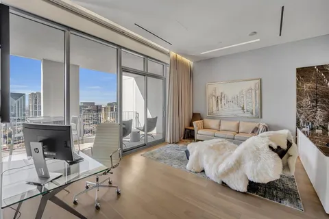 a living room with couches a coffee table and next to a large window