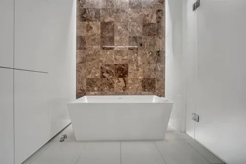 a white bath tub sitting in a bathroom