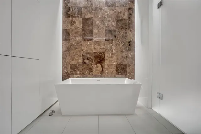 a white bath tub sitting in a bathroom