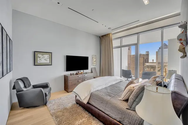 a bedroom with furniture a couch and a flat screen tv