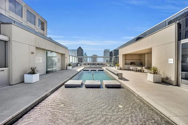 a swimming pool view with a outdoor seating