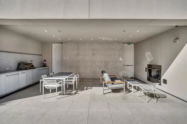 a living room with furniture a air conditioner and a stove