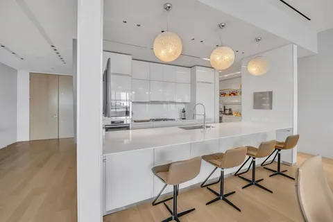 a kitchen with a dining table and chairs in it