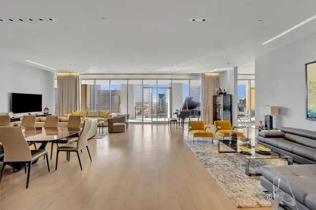 a living room with furniture and floor to ceiling windows