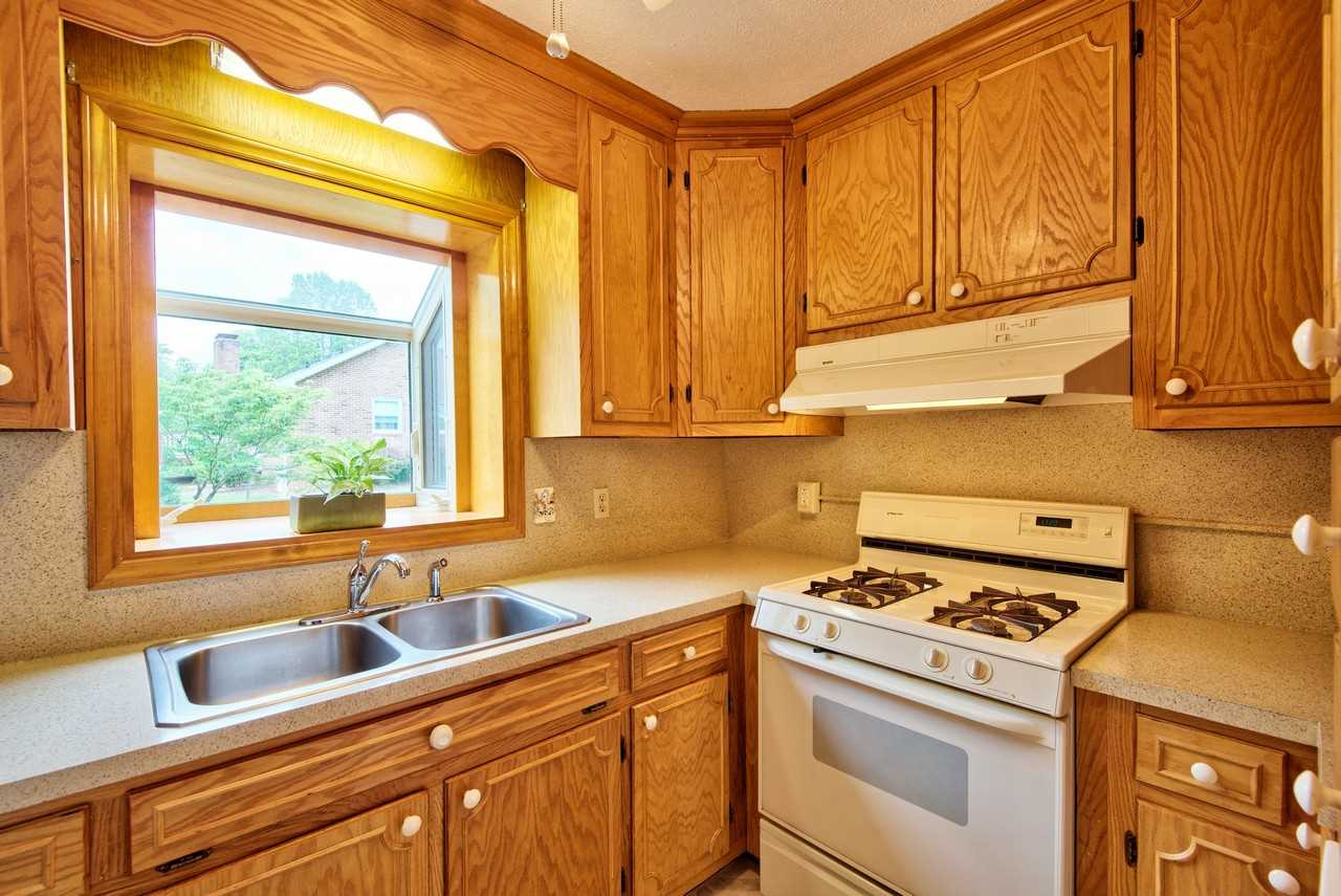3607 Cole Mill Road Durham, NC 27712 - Photo 9 of 25 The kitchen has white appliances and gas stove. The extended window is perfect for an herb garden. Kitchen