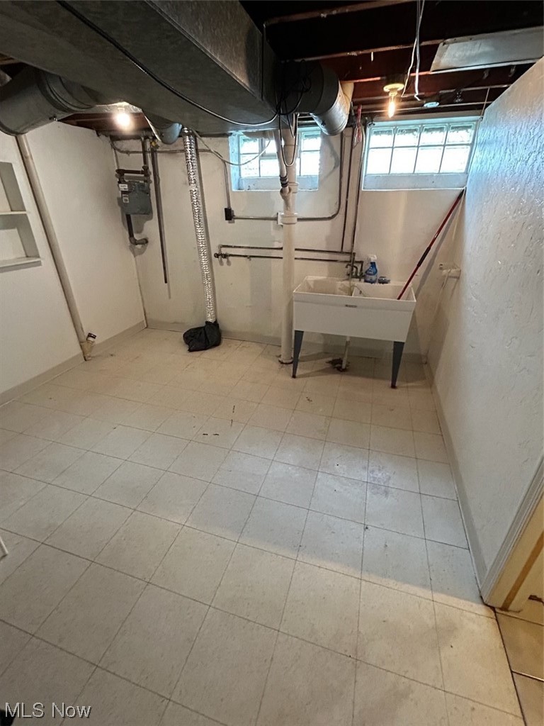 1287 Churchill Road Lyndhurst, OH 44124 - Photo 9 of 27 Basement featuring a wealth of natural light, sink, and light tile floors