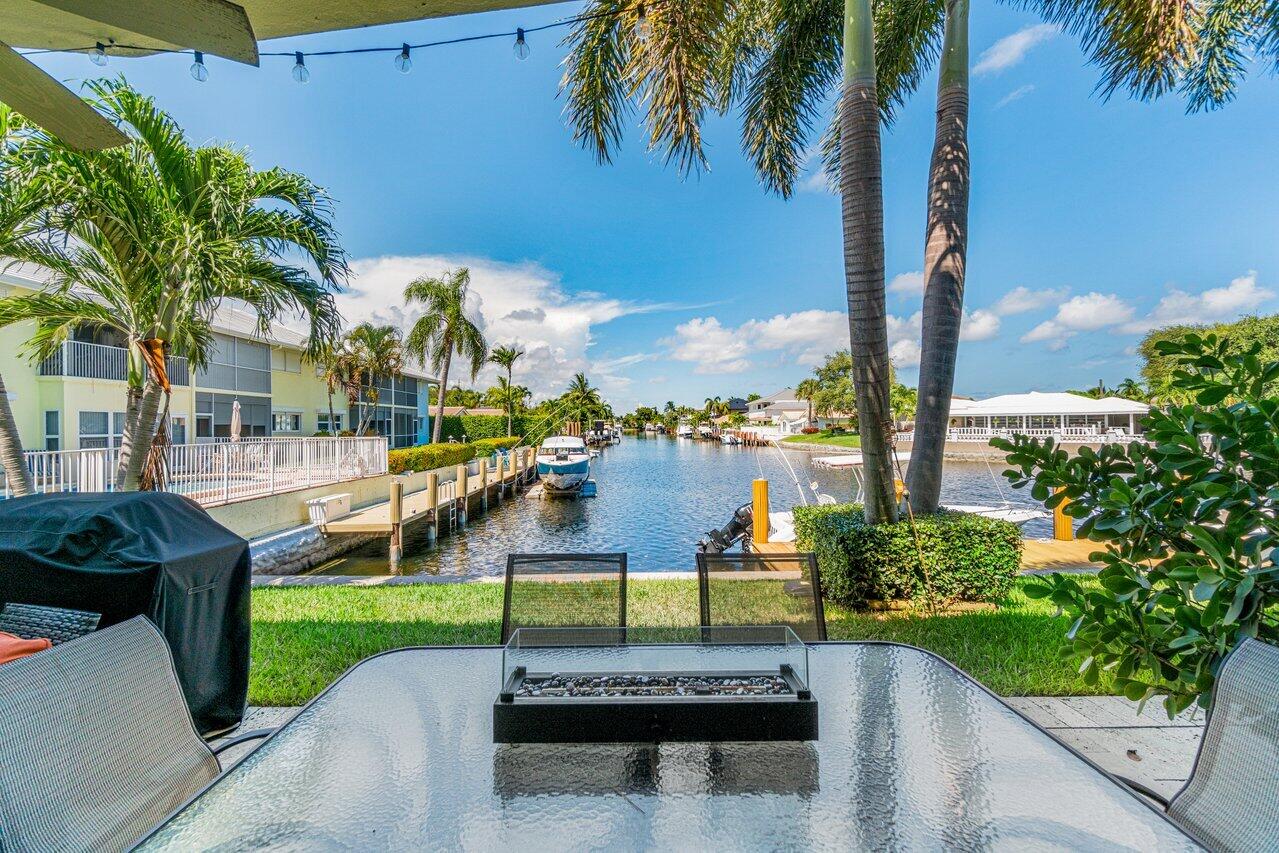 2311 Northeast 36th Street, Unit 1A Lighthouse Point, FL 33064 - Photo 20 of 29 a view of a park with potted plants and palm trees