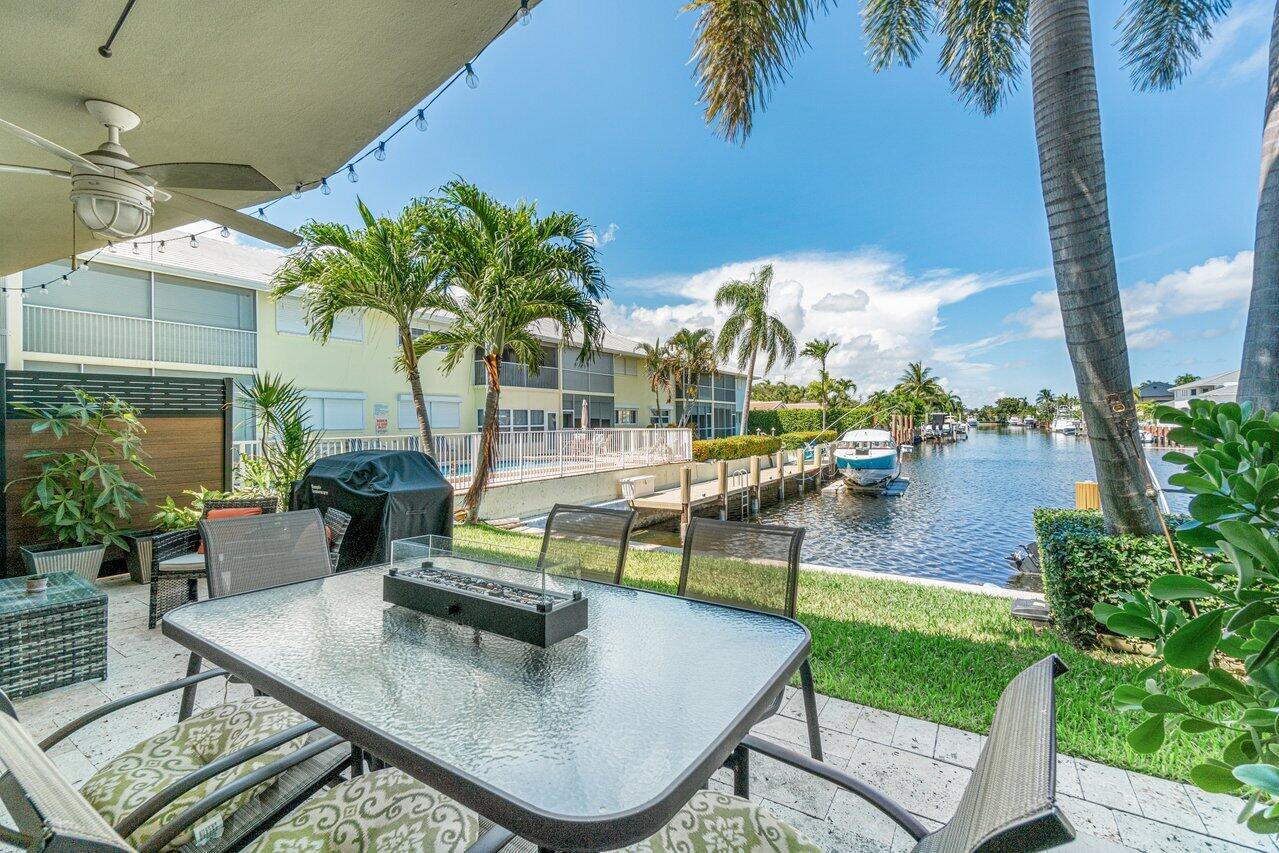2311 Northeast 36th Street, Unit 1A Lighthouse Point, FL 33064 - Photo 21 of 29 a view of a swimming pool with outdoor seating and plants