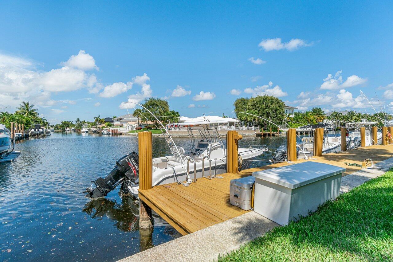 2311 Northeast 36th Street, Unit 1A Lighthouse Point, FL 33064 - Photo 26 of 29 a view of a house with yard and sitting area