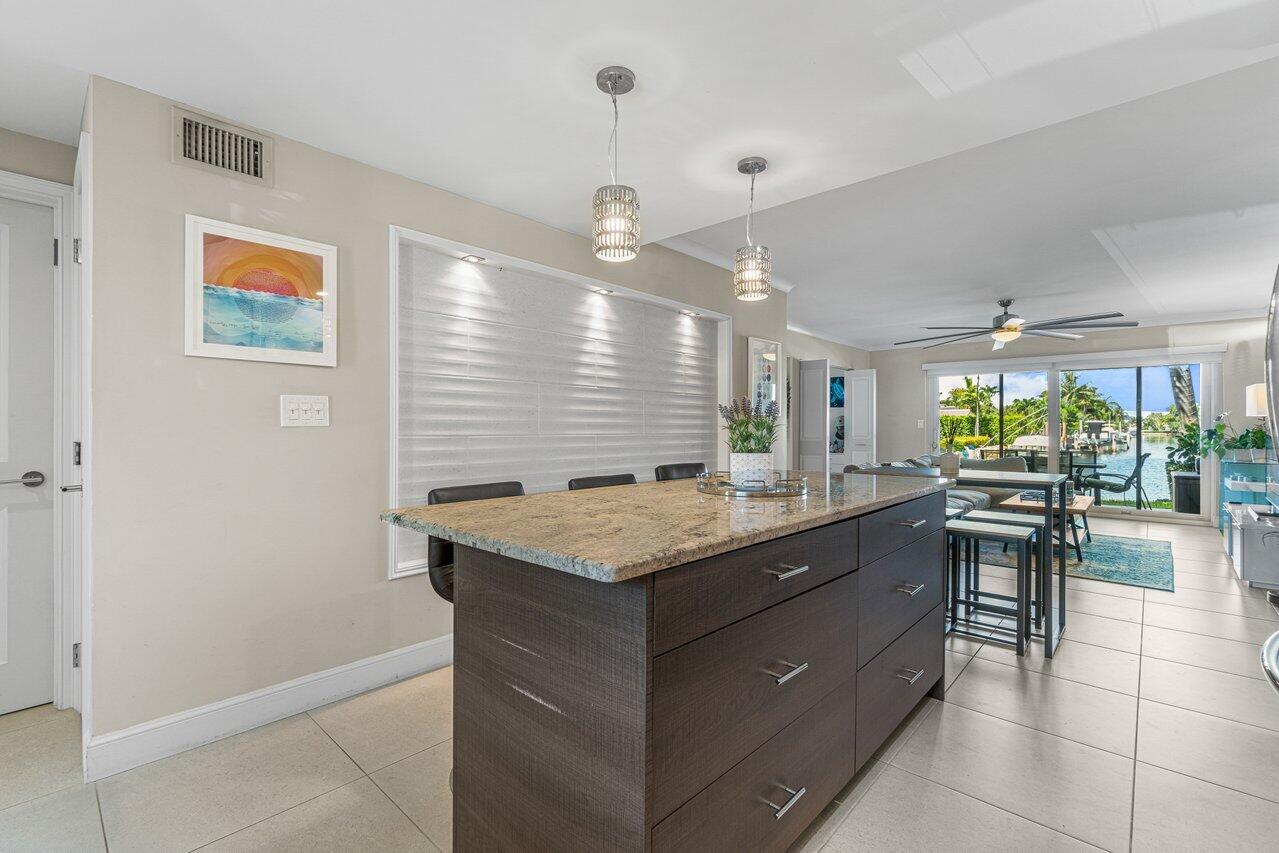 2311 Northeast 36th Street, Unit 1A Lighthouse Point, FL 33064 - Photo 7 of 29 a kitchen with a stove and cabinets
