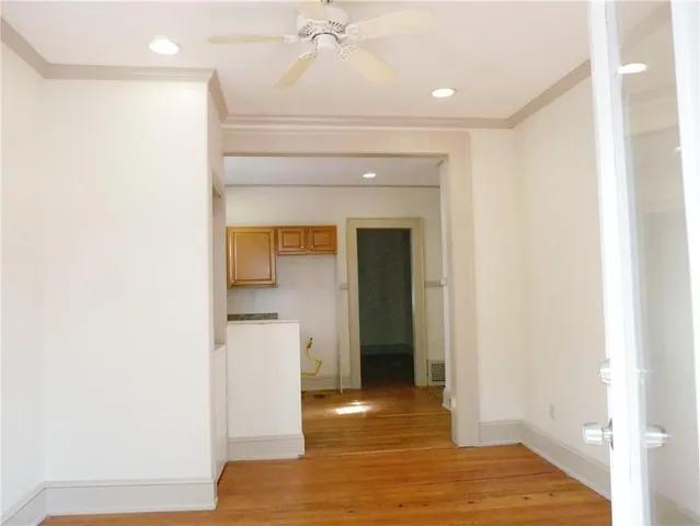 a view of a hallway with wooden floor