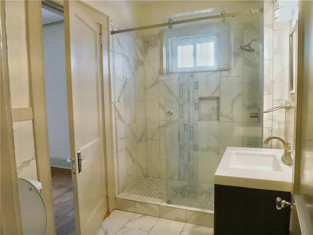a bathroom with a shower and sink