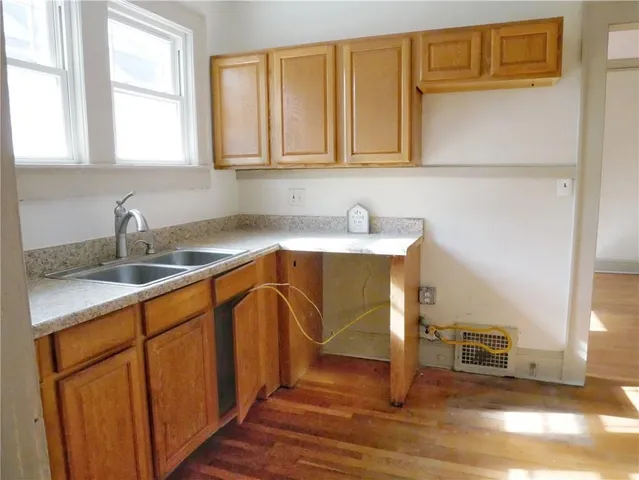 a kitchen with stainless steel appliances granite countertop a sink dishwasher stove and cabinets