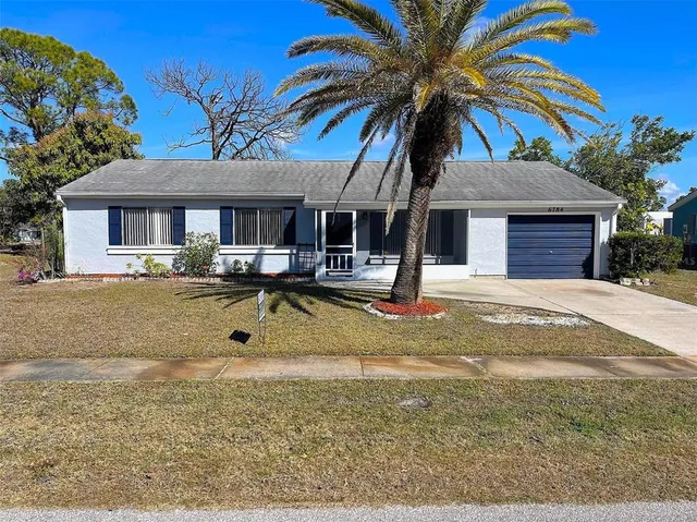 a view of a house with swimming pool and porch