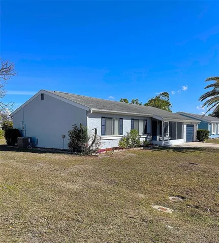 a front view of a house with yard patio and fire pit