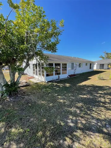 a view of a house with a yard and sitting area
