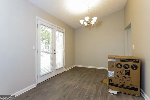 a view of a room with wooden floor