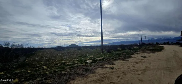 a view of a building and mountains in the background