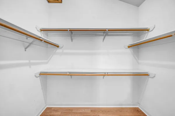 an empty room with windows and ceiling fan