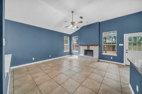 a view of empty room with windows and fireplace