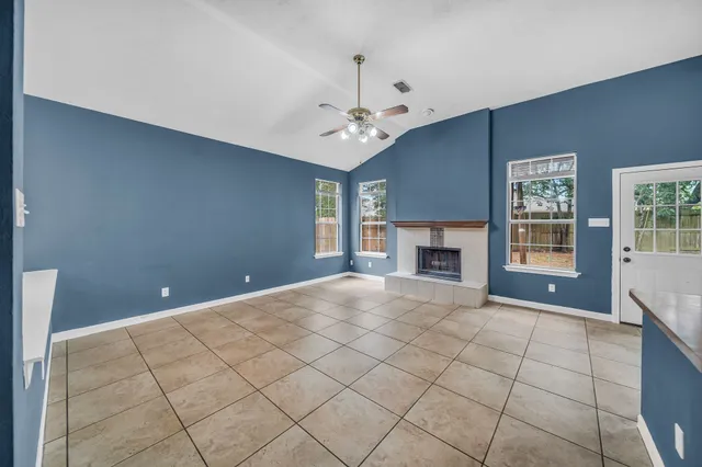 a view of empty room with windows and fireplace