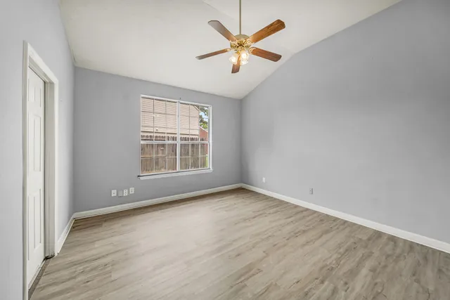 wooden floor in an empty room with a window
