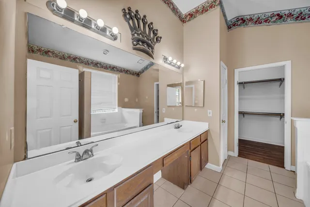 a spacious bathroom with a granite countertop sink mirror and vanity