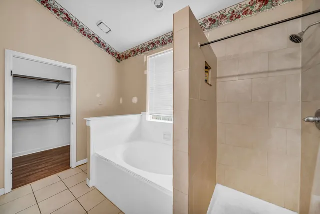 a bathroom with a bathtub and a shower