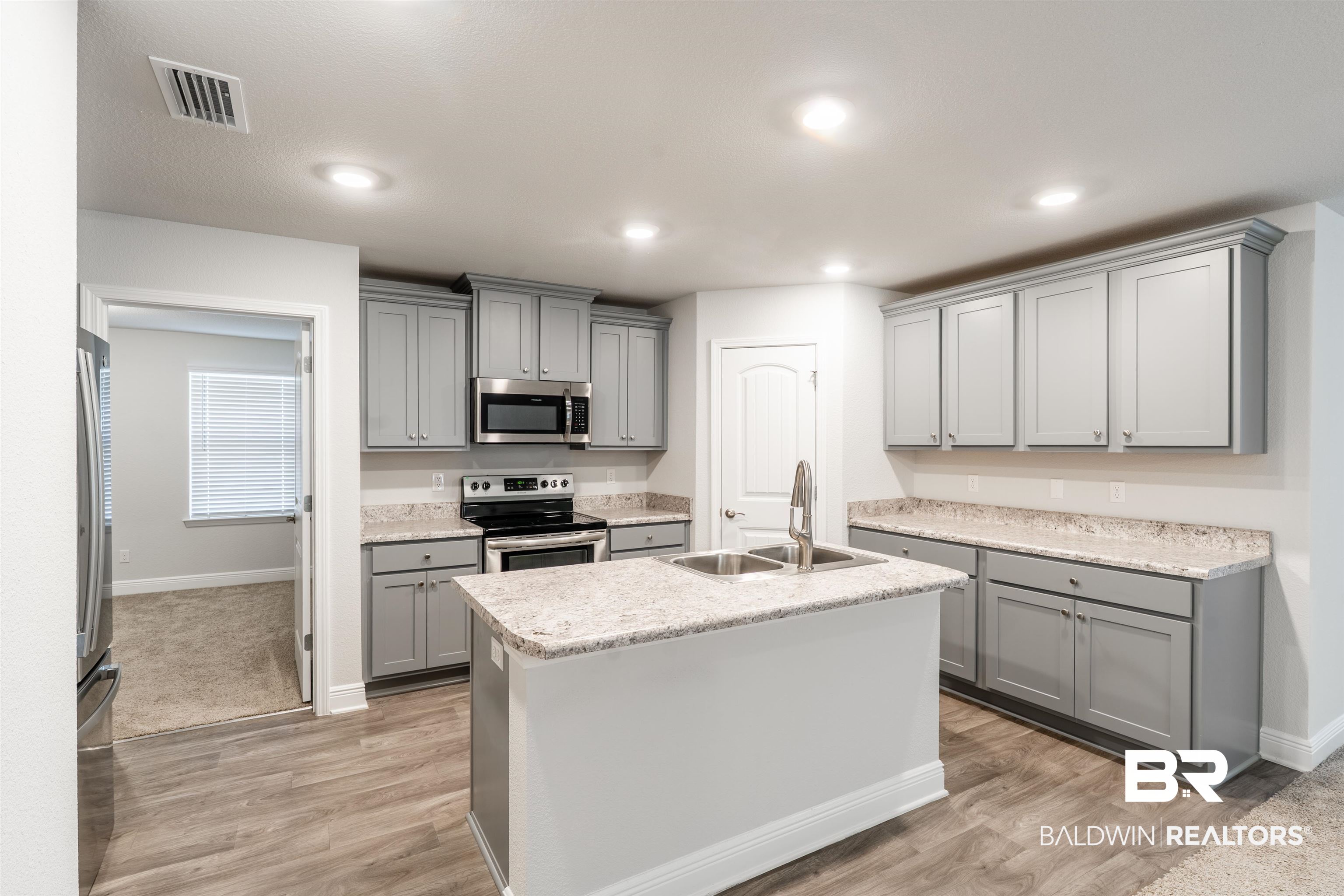 1906 Stonepine Drive South Semmes, AL 36575 - Photo 6 of 30 Kitchen with gray cabinets, appliances with stainless steel finishes, an island with sink, and recessed lighting