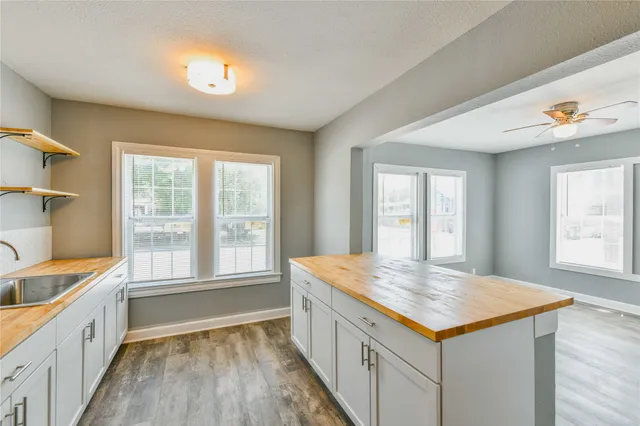 a kitchen with granite countertop a sink and wooden floor