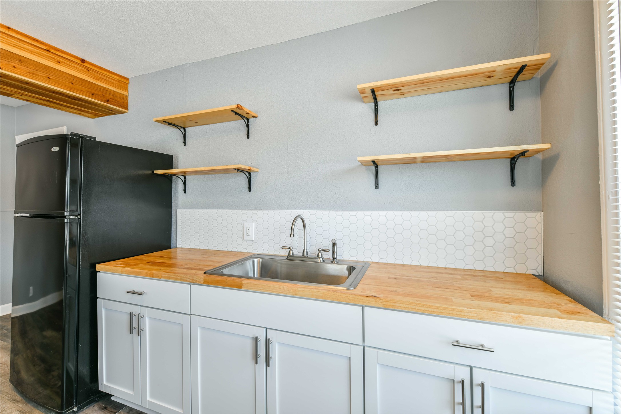 4615 Schroeder Street, Unit 1 Houston, TX 77011 - Photo 14 of 28 a kitchen with a sink cabinets and refrigerator
