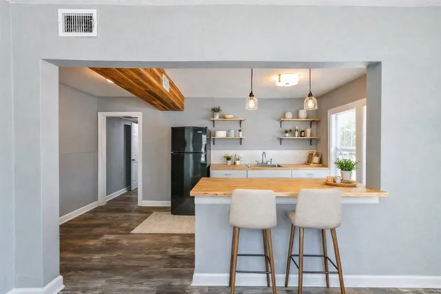 a room with stainless steel appliances kitchen island granite countertop furniture and a kitchen view