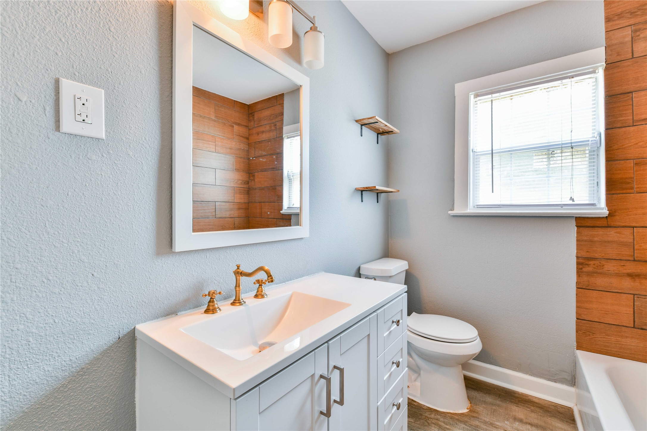 4615 Schroeder Street, Unit 1 Houston, TX 77011 - Photo 22 of 28 a bathroom with a sink a toilet and a window