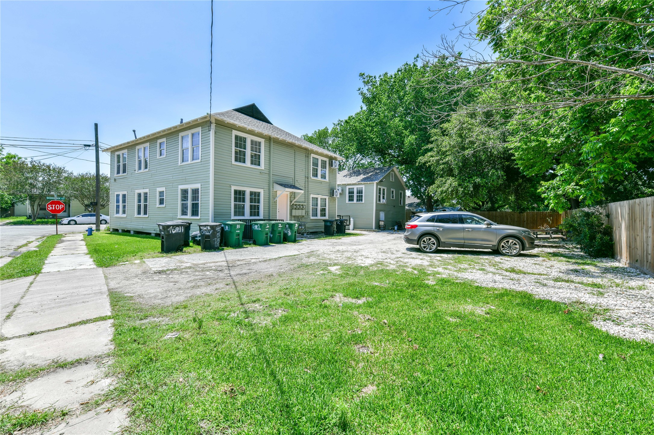 4615 Schroeder Street, Unit 1 Houston, TX 77011 - Photo 27 of 28 a car parked in front of white house with a yard