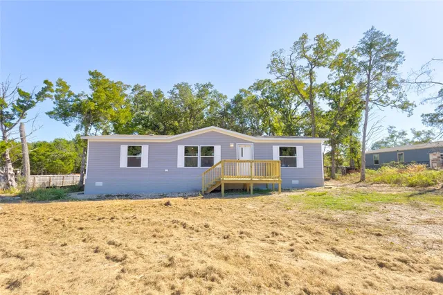 a house that has a tree in front of it