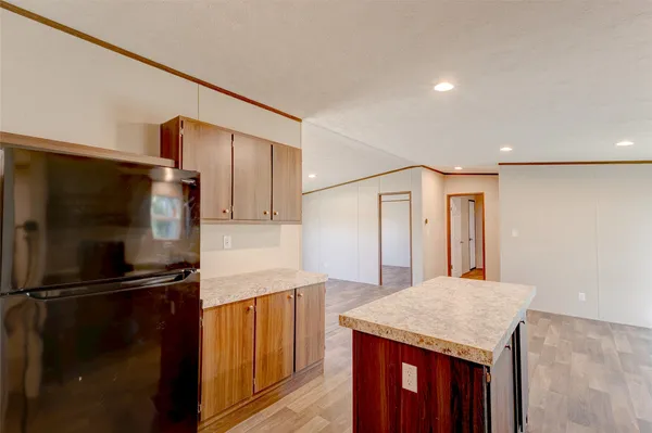 a large kitchen with kitchen island granite countertop wooden cabinets a sink and dishwasher