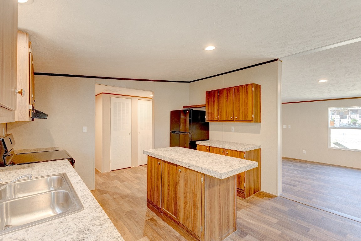 107 Los Cueva Road Elgin, TX 78621 - Photo 15 of 31 a view of a kitchen with a sink and a refrigerator
