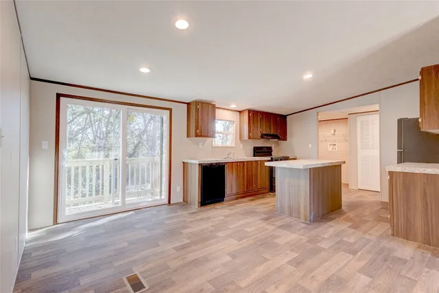 a large white kitchen with a large window