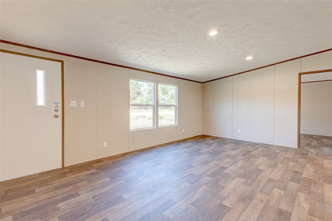 107 Los Cueva Road Elgin, TX 78621 - Photo 28 of 31 a view of an empty room with wooden floor and a window