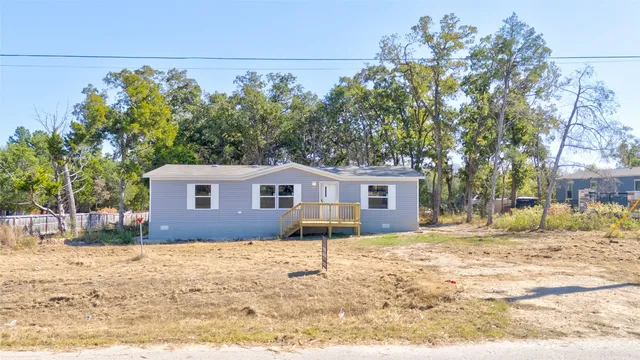 a house that has a tree in front of it