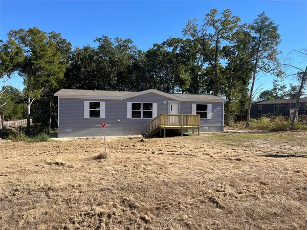 a house with trees in the background
