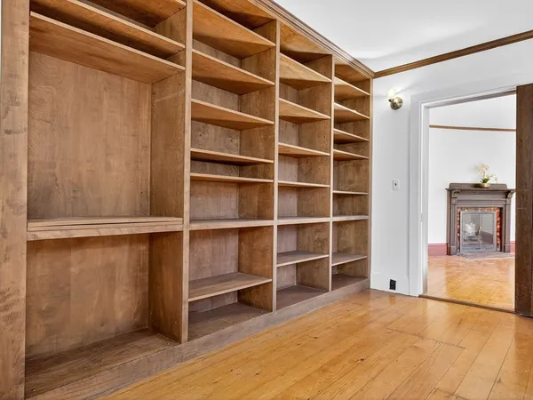 a view of an empty room with closet and a window