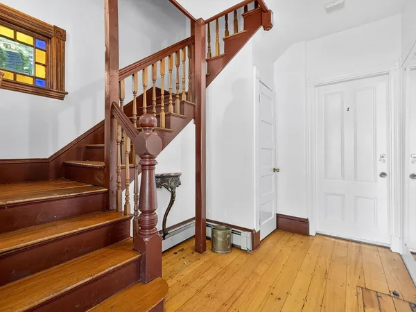 a view of entryway and hall with wooden floor