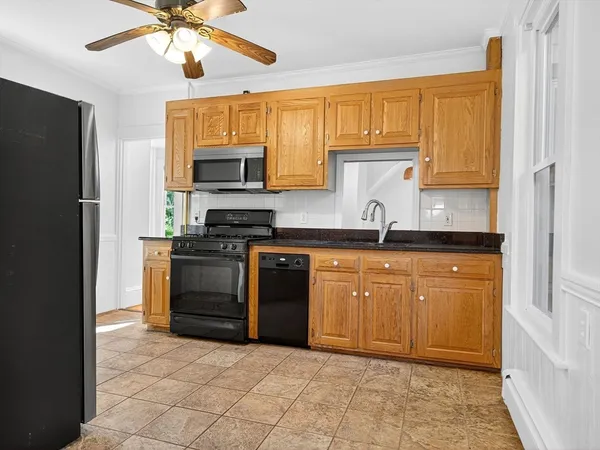 a kitchen with stainless steel appliances granite countertop a stove sink and cabinets