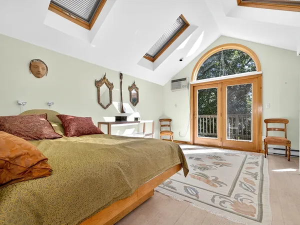 a bedroom with a large bed and a window