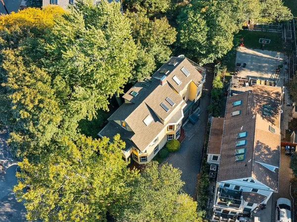 an aerial view of a house with a yard and garden